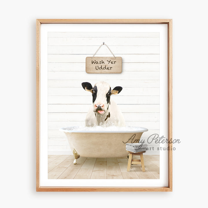 a cow sitting in a bathtub with a sign above it