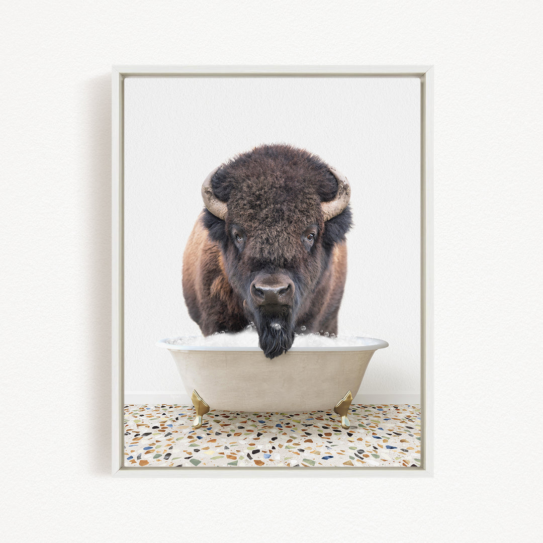 A bison with a long beard is standing in a white bathtub filled with water, creating a humorous and unexpected scene.
