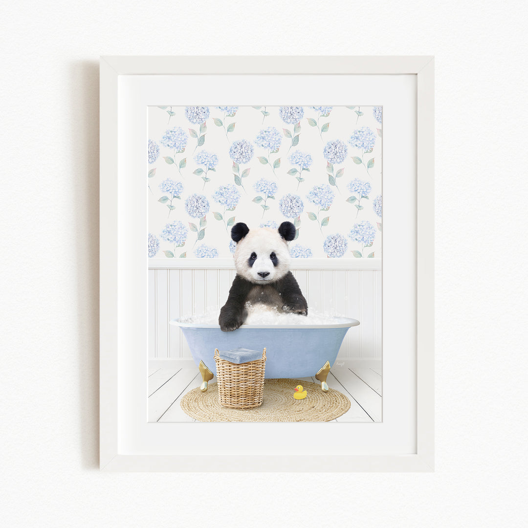 A panda bear sitting in a blue bathtub filled with bubbles, surrounded by a floral patterned wall and a basket of rubber ducks.
