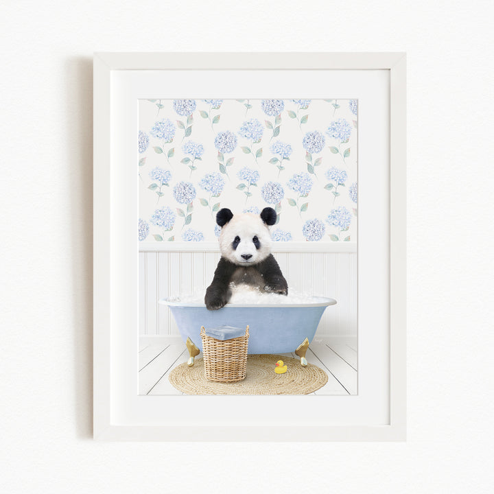 A panda bear sitting in a blue bathtub filled with bubbles, surrounded by a floral patterned wall and a basket of rubber ducks.