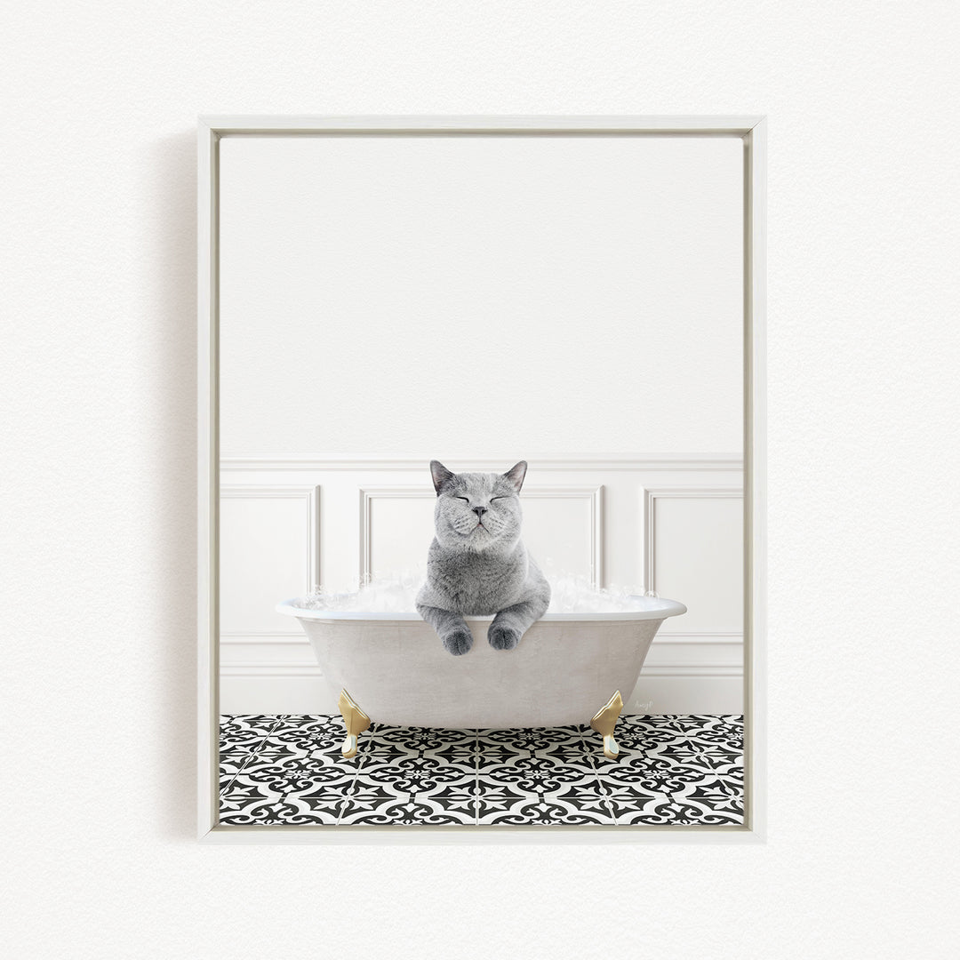 A gray cat sitting in a white bathtub filled with bubbles, with a black and white patterned floor in the background.