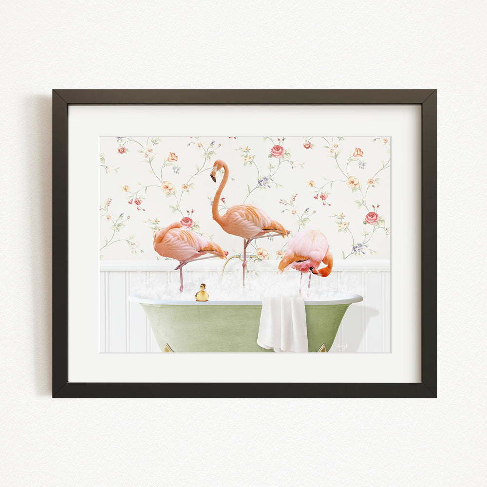 A framed image depicting three pink flamingos standing in a green bathtub filled with water, surrounded by a floral pattern.