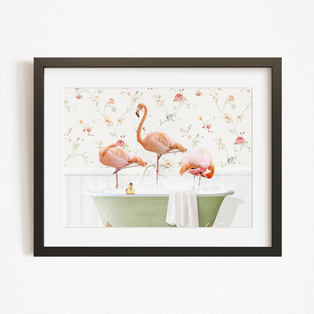 A framed image depicting three pink flamingos standing in a green bathtub filled with water, surrounded by a floral pattern.