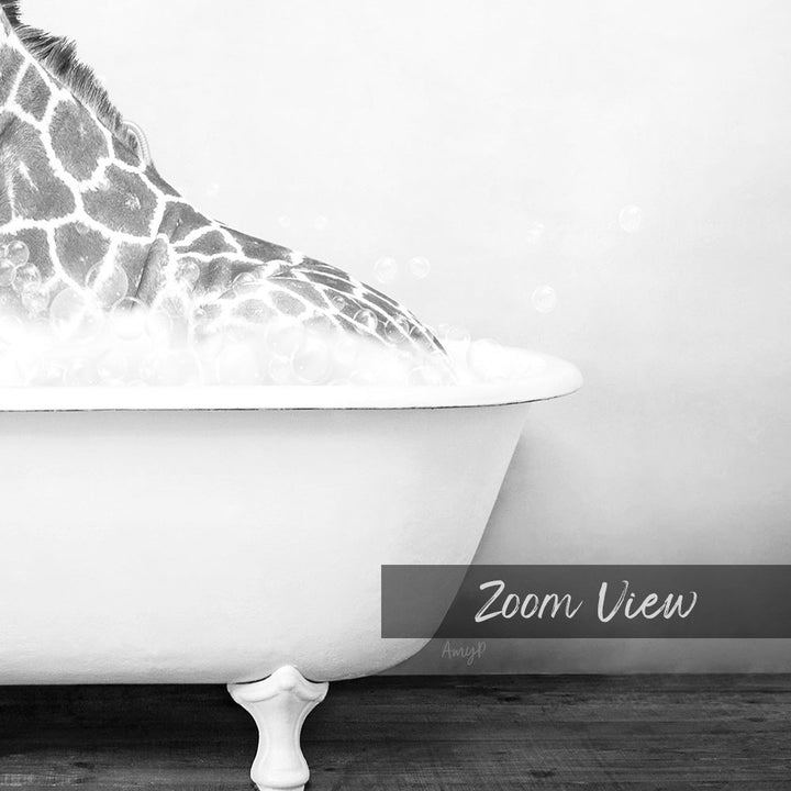 A close-up black and white image of a giraffe standing in a bathtub filled with water, with bubbles visible around its neck.