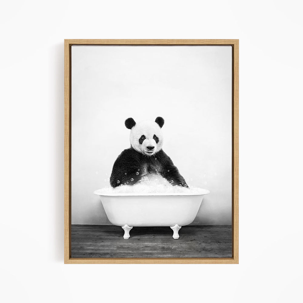 A panda bear sitting in a bathtub filled with bubbles, creating a whimsical and playful scene.