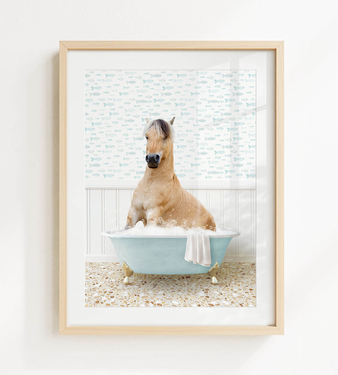 A light brown horse is sitting in a blue bathtub filled with bubbles, surrounded by a patterned wall and a white floor.