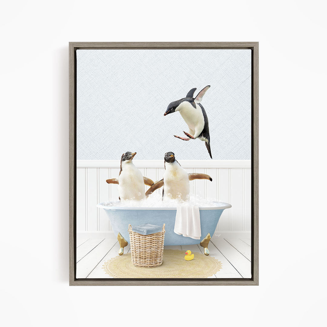 A framed image depicting two penguins sitting in a bathtub, with one penguin flying towards the other penguin.