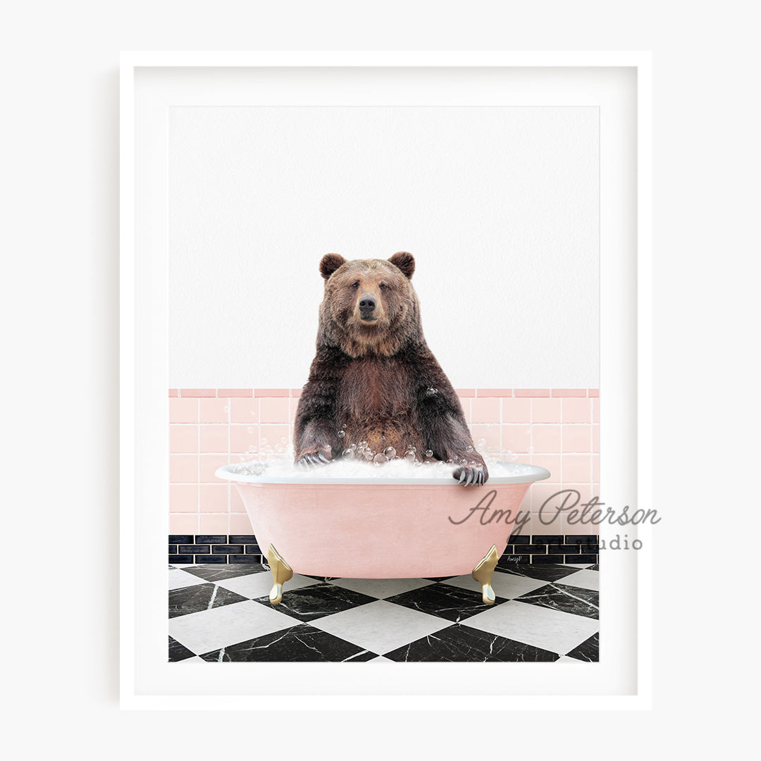 a brown bear sitting in a pink bath tub