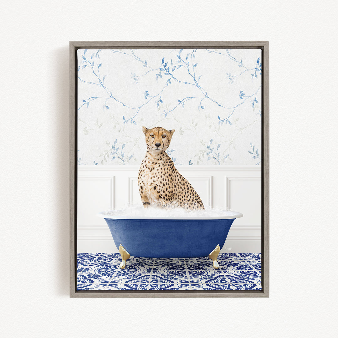 A cheetah sitting in a blue bathtub, surrounded by a patterned tile floor and a floral wallpaper background.