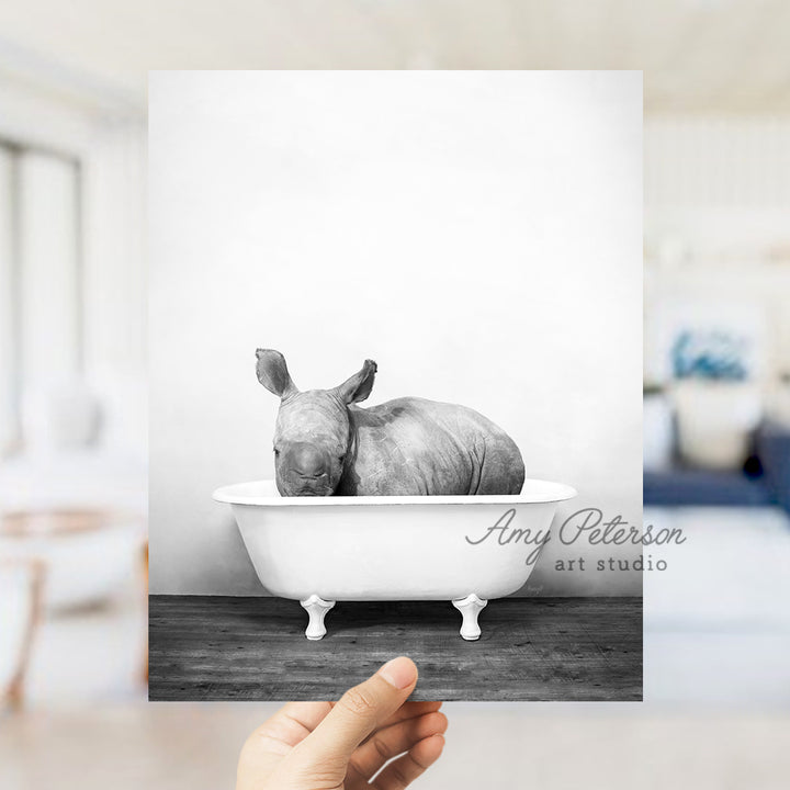 a rhinoceros in a bathtub in a living room