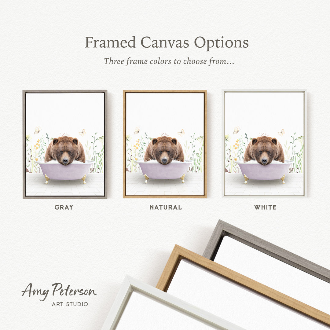three framed canvas options for a painting of a bear in a bathtub, each with a different frame color: gray, natural, and white.