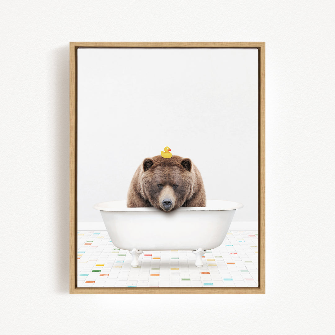 A brown bear is sitting in a white bathtub, with a yellow rubber duck perched on its head.
