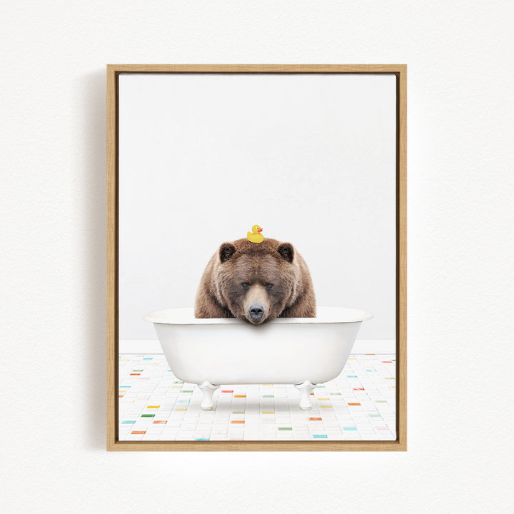 A brown bear is sitting in a white bathtub, with a yellow rubber duck perched on its head.