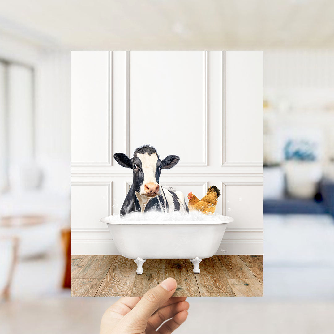 A cow is sitting in a bathtub filled with water, with a chicken nearby, in a white room with a wooden floor.