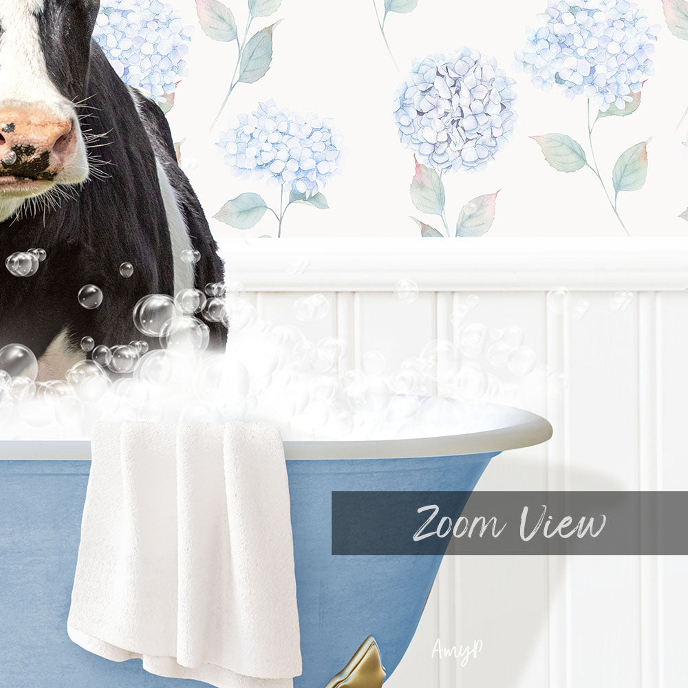 A cow is sitting in a blue bathtub filled with bubbles, with a floral pattern on the wall behind it.