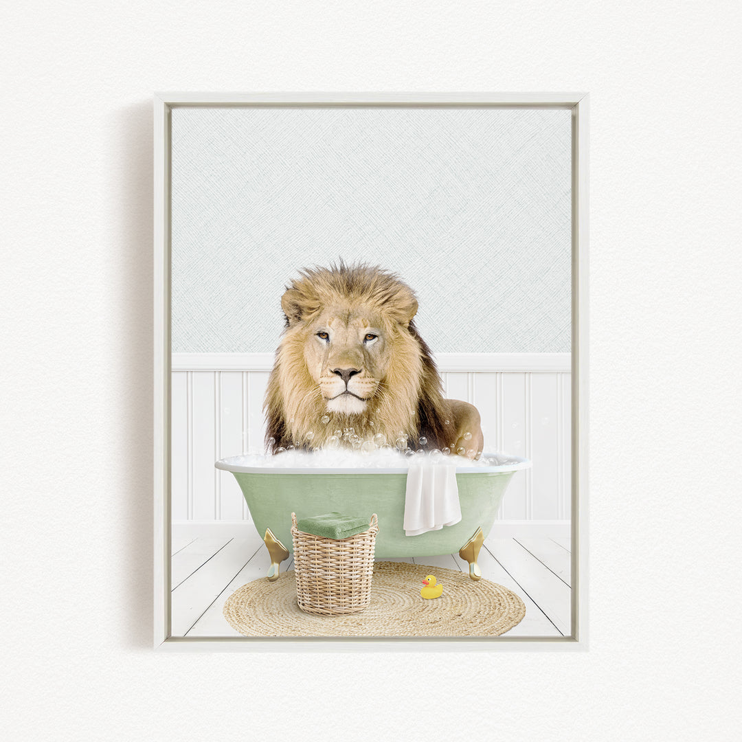 A lion sitting in a green bathtub filled with water, surrounded by a basket, a rubber duck, and a towel.