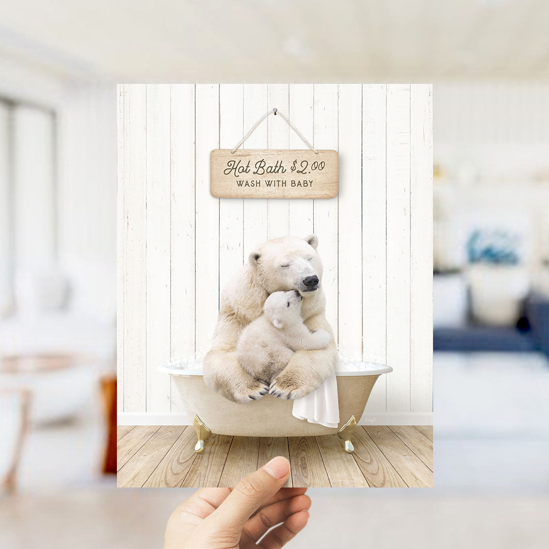 A hand holding a framed image of a polar bear sitting in a bathtub, with a sign above it that says "Hot Bath $2.00 WASH WITH BABY".