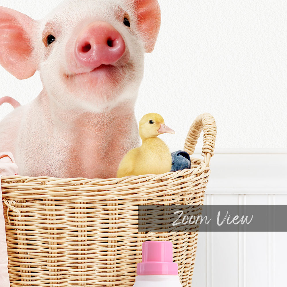 A pink pig sits in a wicker basket, accompanied by a yellow duckling, with a pink bottle and a white wall in the background.