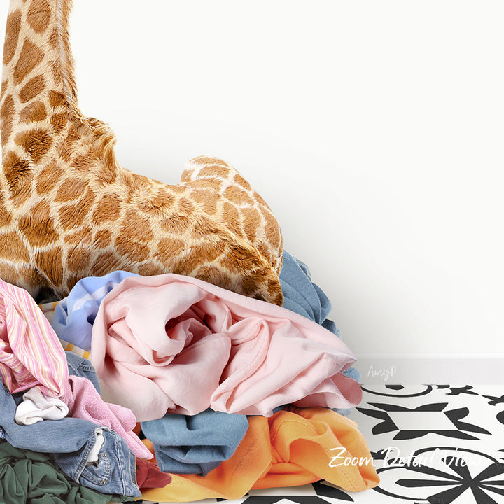 A pile of colorful clothes, including a giraffe stuffed animal, is stacked on top of each other against a plain white background.