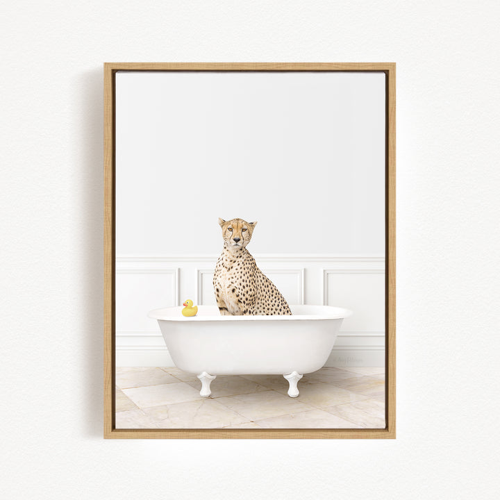 A cheetah sits in a white bathtub, with a yellow rubber duck floating in the water.