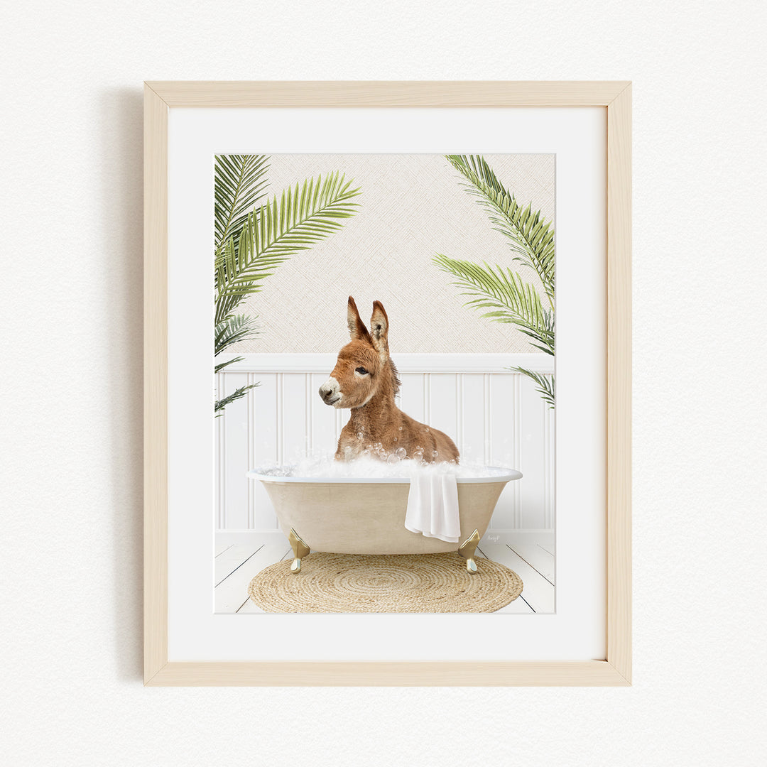 A donkey is sitting in a bathtub filled with water, surrounded by palm leaves, creating a whimsical and playful scene.
