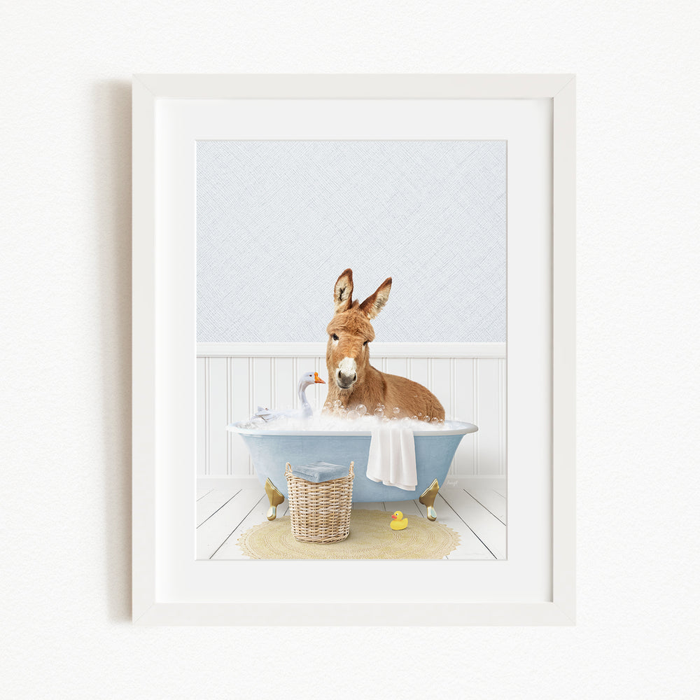A donkey is sitting in a blue bathtub filled with water, surrounded by various bath toys, including a rubber duck and a small bird.