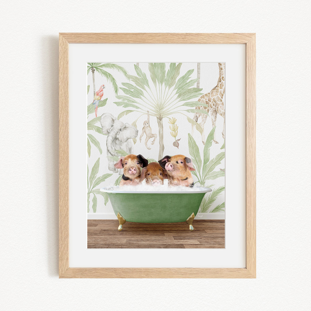 A framed print depicting three pigs sitting in a green bathtub, surrounded by a tropical jungle wallpaper.