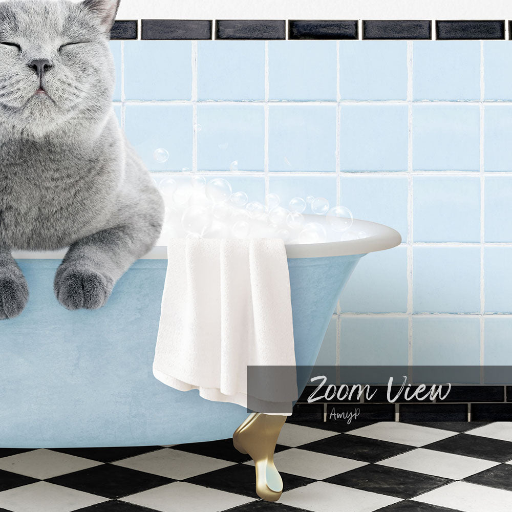 A gray cat sitting in a blue bathtub filled with bubbles, with a towel draped over the side and a black and white checkered floor in the background.