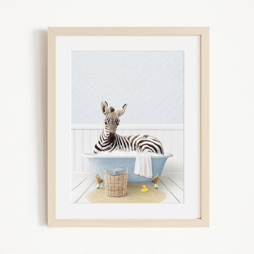 A zebra is sitting in a blue bathtub filled with water, surrounded by rubber ducks and a basket.