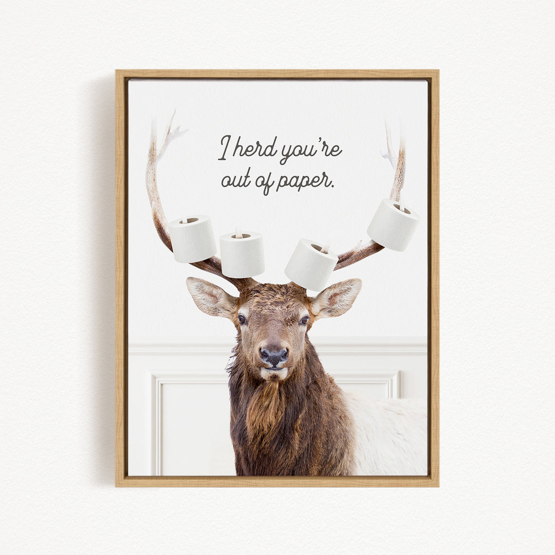 A deer with antlers wearing multiple rolls of toilet paper, accompanied by the text "I herd you're out of paper."