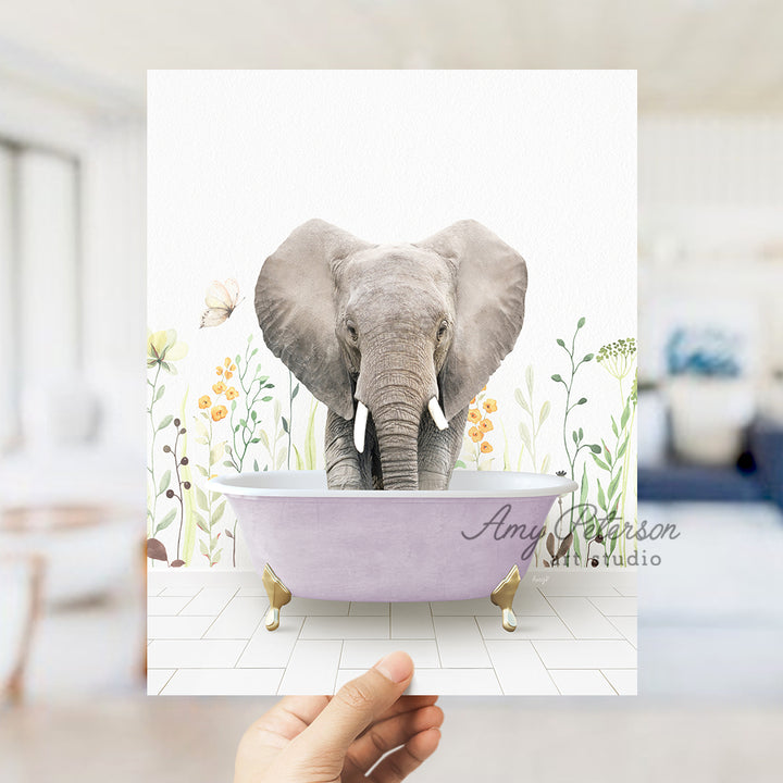 a person holding up a card with an elephant in a bathtub