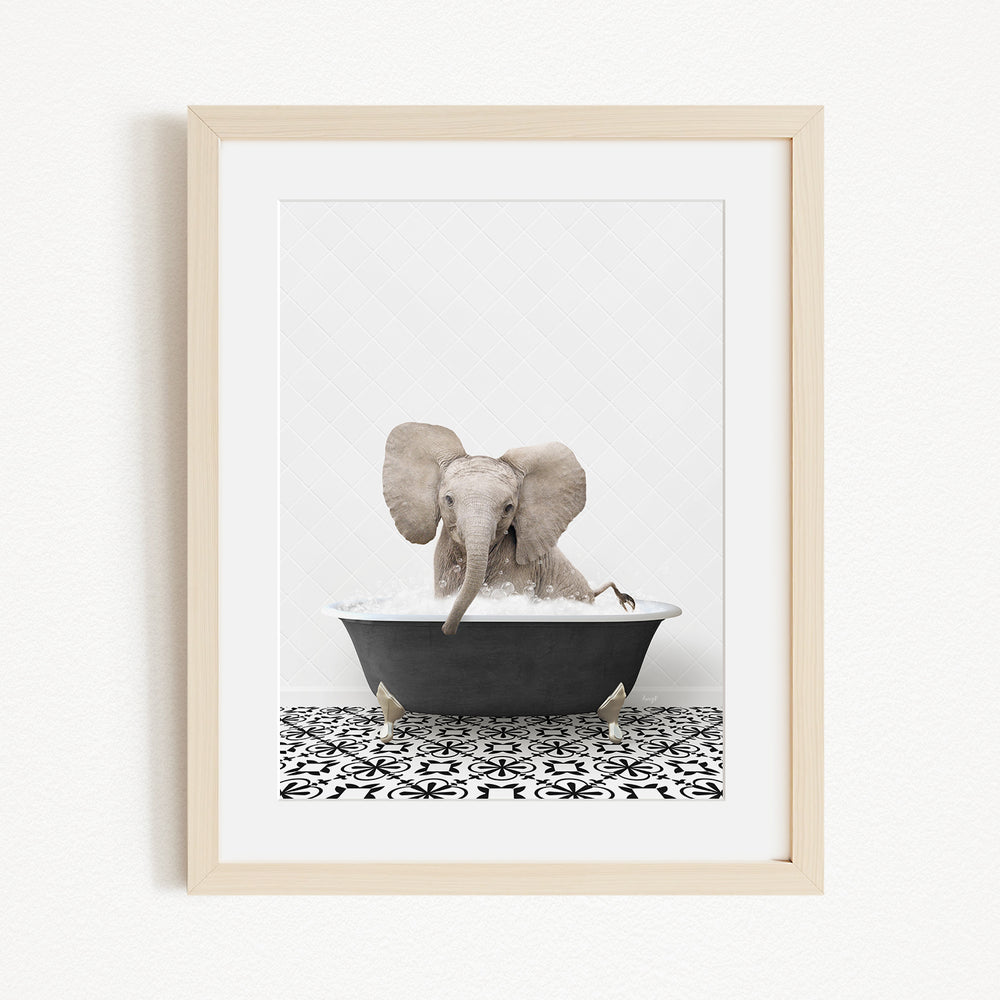 A gray elephant is sitting in a black bathtub filled with water, surrounded by a black and white patterned floor.