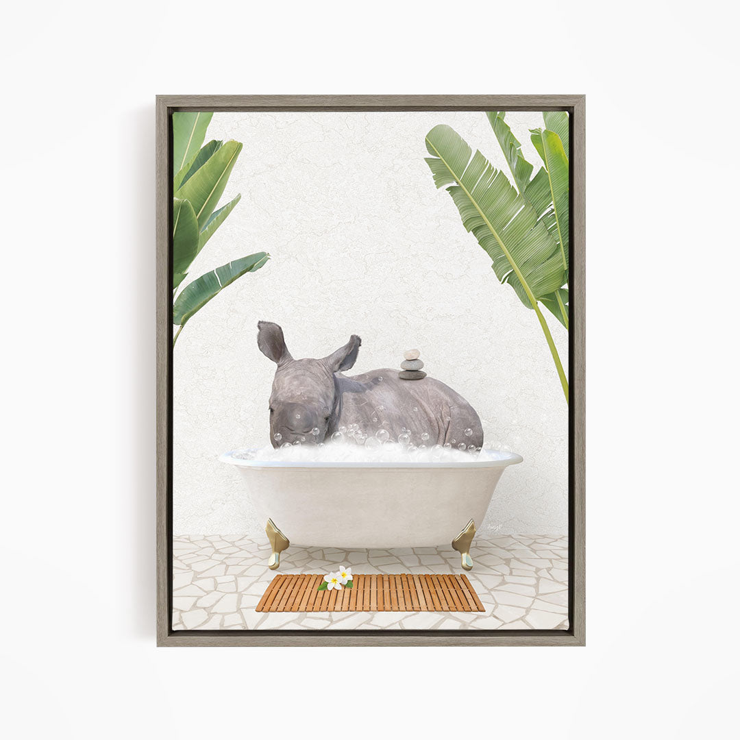 A rhinoceros is sitting in a bathtub filled with water, surrounded by tropical plants and a wooden mat on the floor.