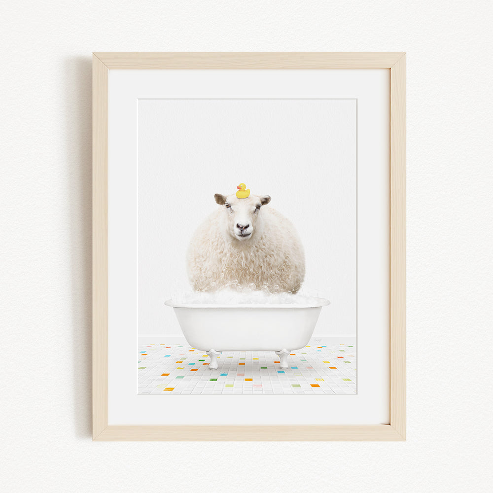 A white sheep with a yellow duck sitting in a white bathtub, surrounded by colorful tiles on the floor.