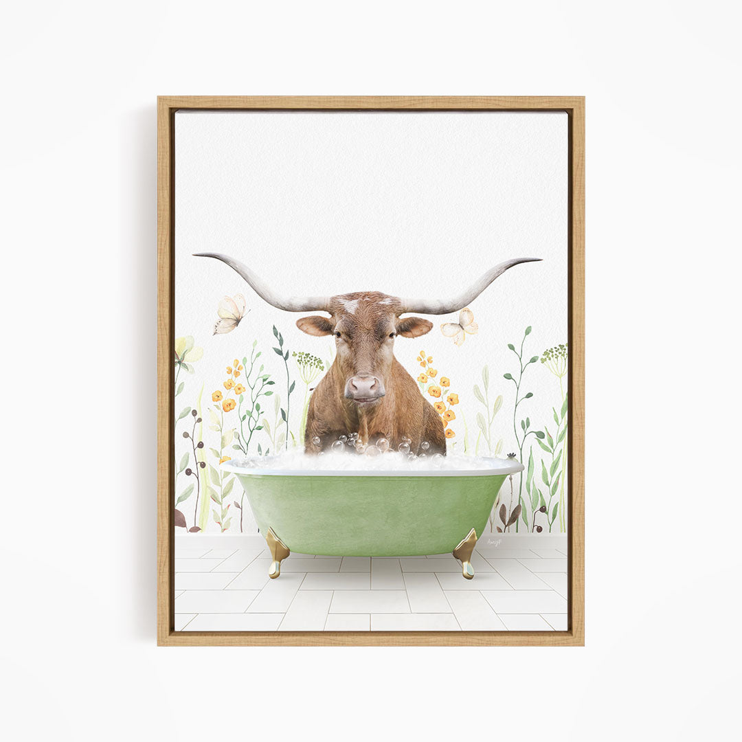 A brown cow with large horns is sitting in a green bathtub filled with water, surrounded by flowers and plants.