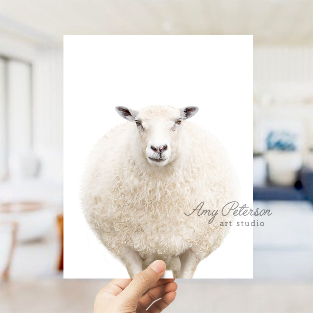 a person holding a card with a sheep on it