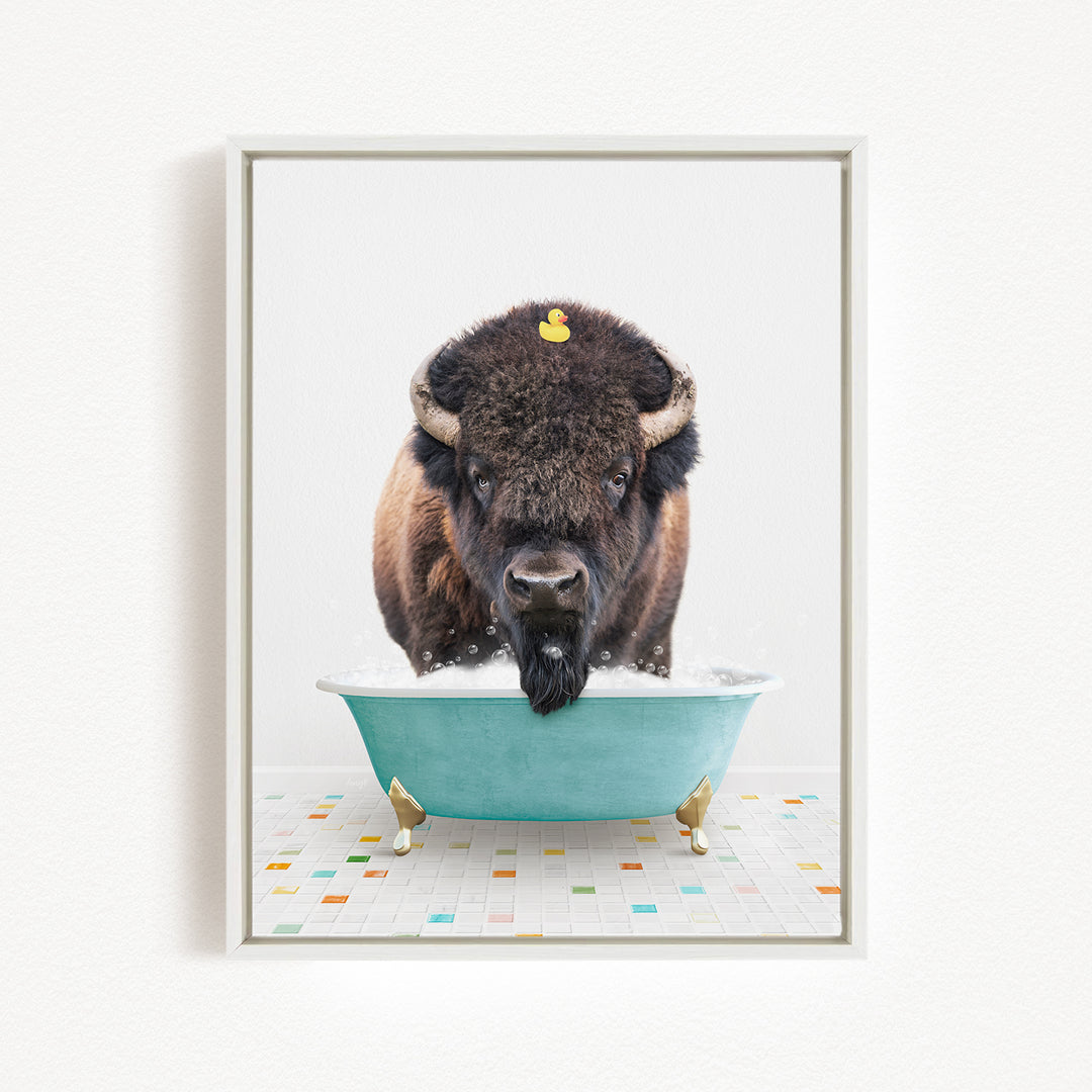 A buffalo with a yellow rubber duck sitting in a blue bathtub.
