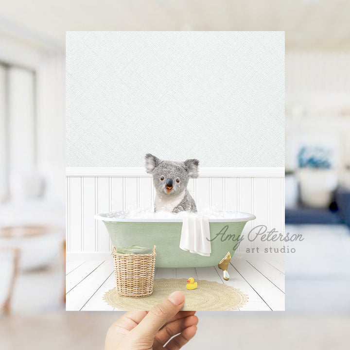 a person holding a card with a picture of a koala in a bathtub