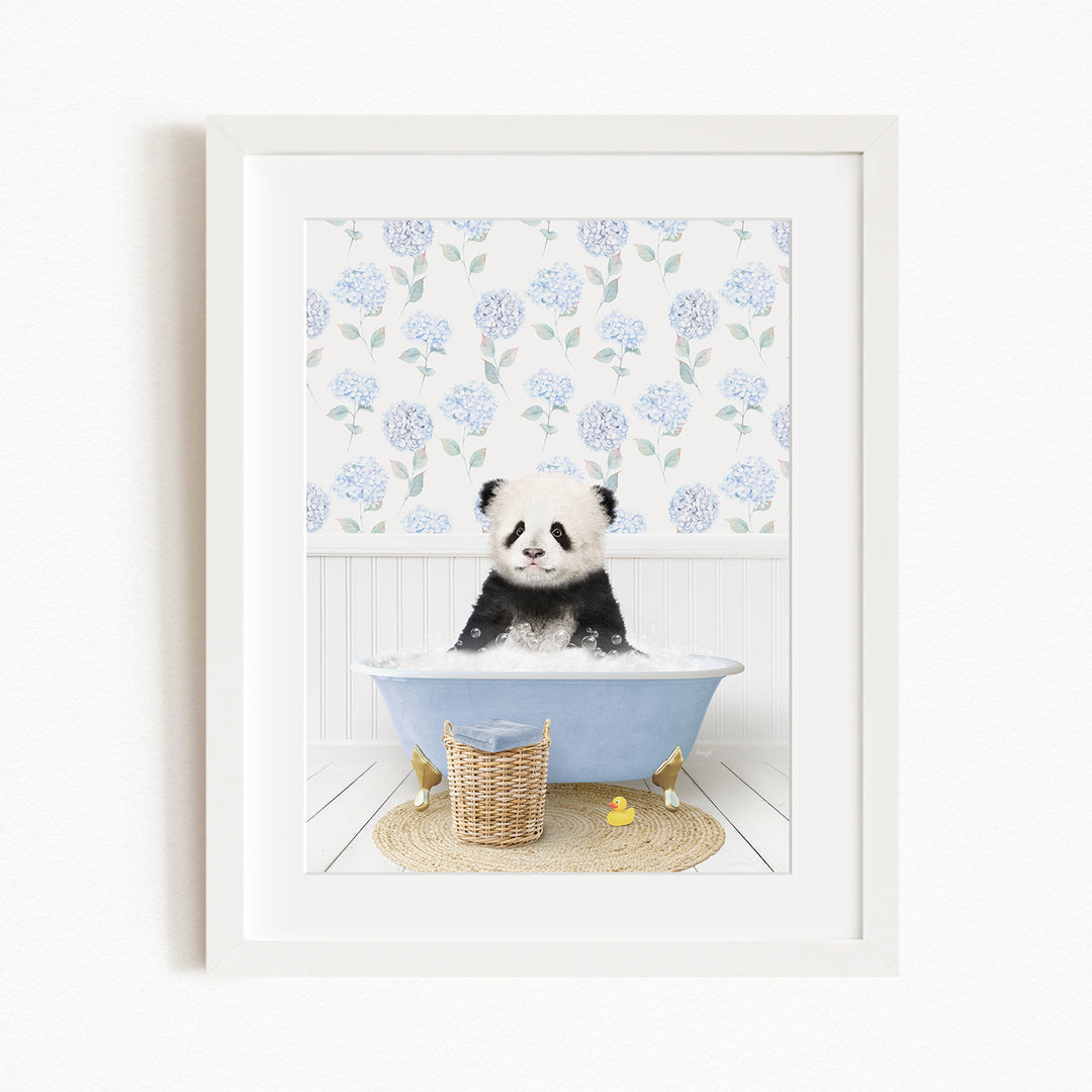 A panda bear sitting in a blue bathtub filled with bubbles, surrounded by a floral patterned wall and a basket of rubber ducks.