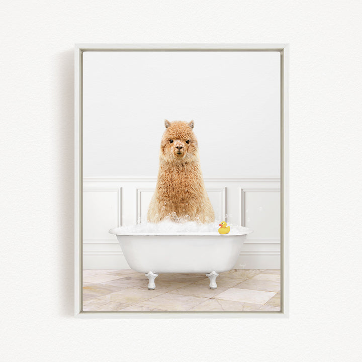 A fluffy alpaca sits in a white bathtub filled with water, with a rubber duck floating nearby.