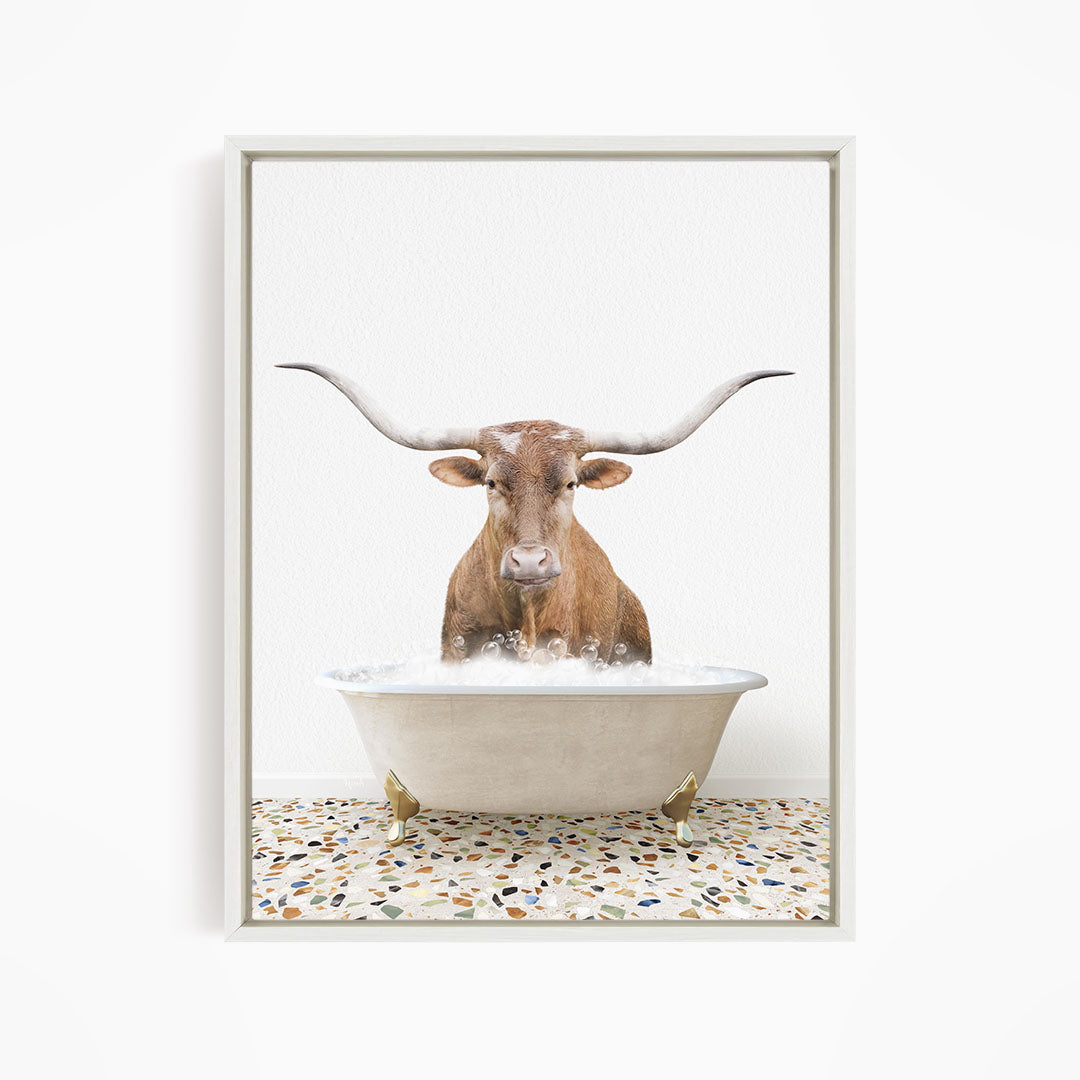 A brown bull with large horns is standing in a white bathtub filled with water, creating a whimsical and playful scene.