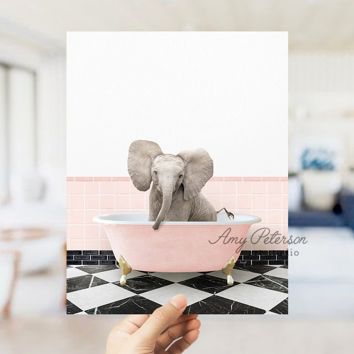 a person holding up a card with an elephant in a bathtub