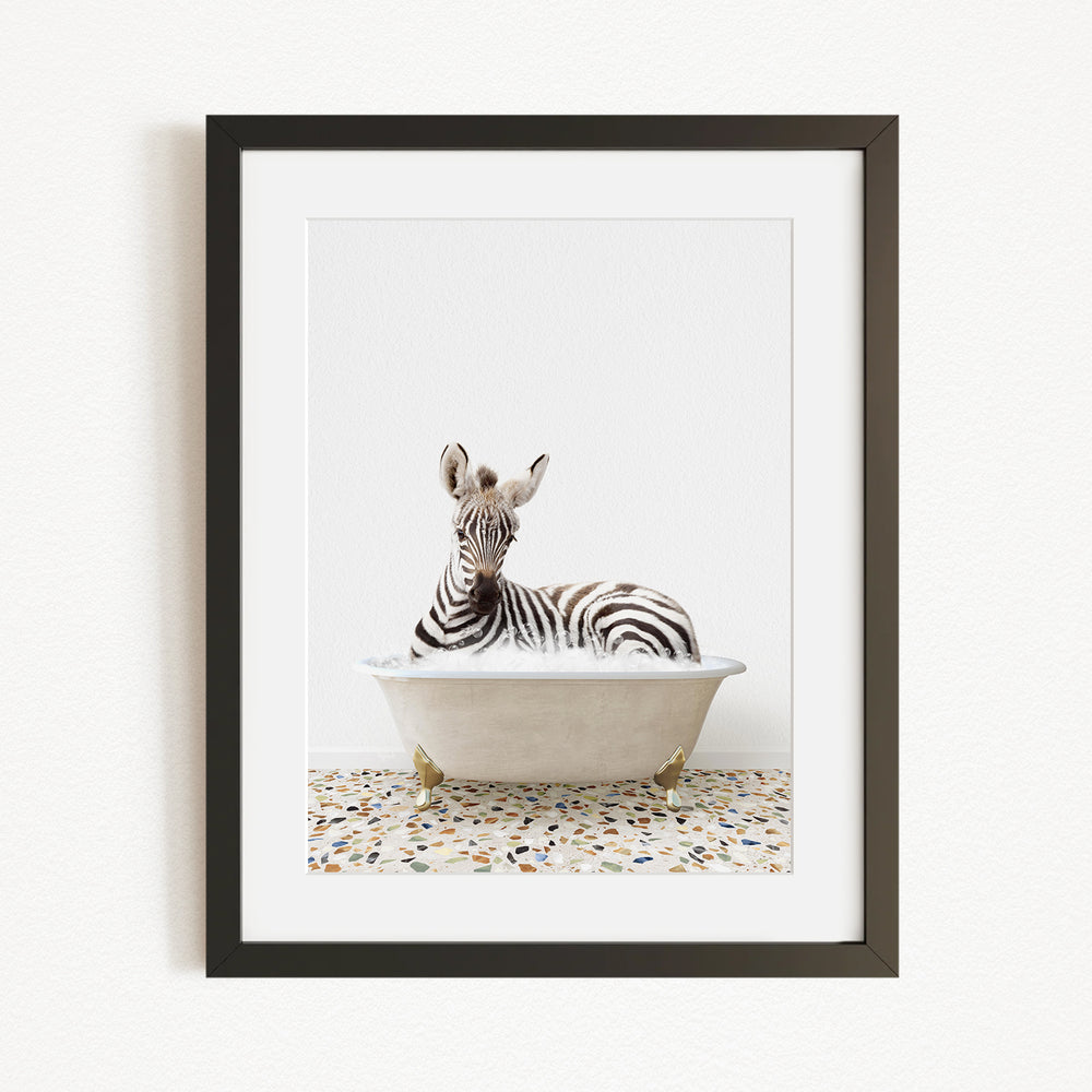 A zebra is sitting in a bathtub filled with water, creating a whimsical and playful scene.