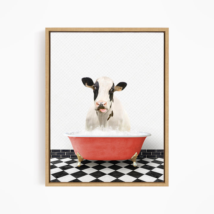 A black and white cow is sitting in a red bathtub filled with water, creating a whimsical and humorous scene.
