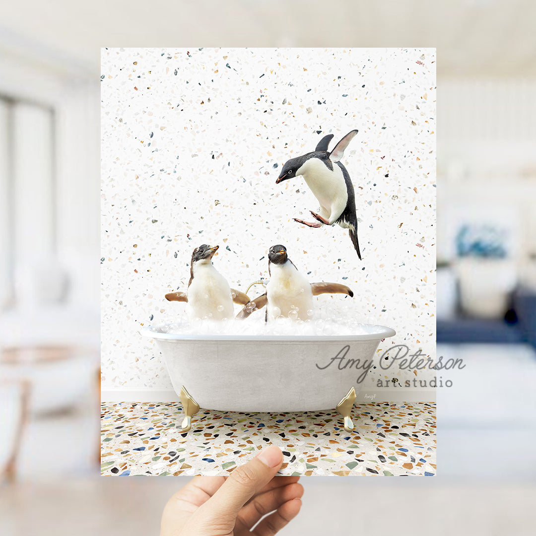 a hand holding up a card with penguins in a bathtub