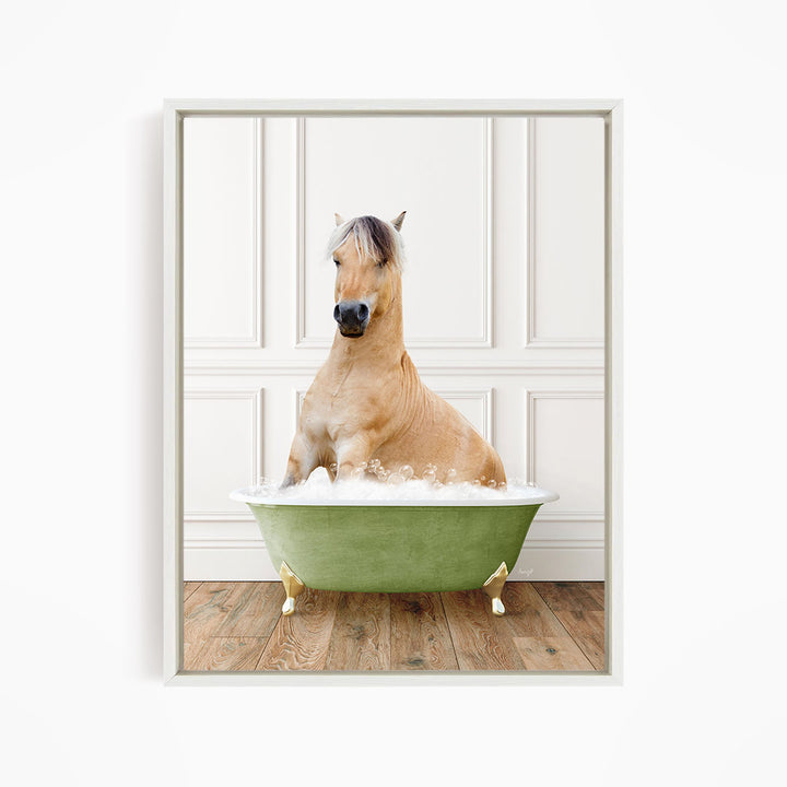 A light brown horse is sitting in a green bathtub filled with water, with its head raised and looking directly at the camera.