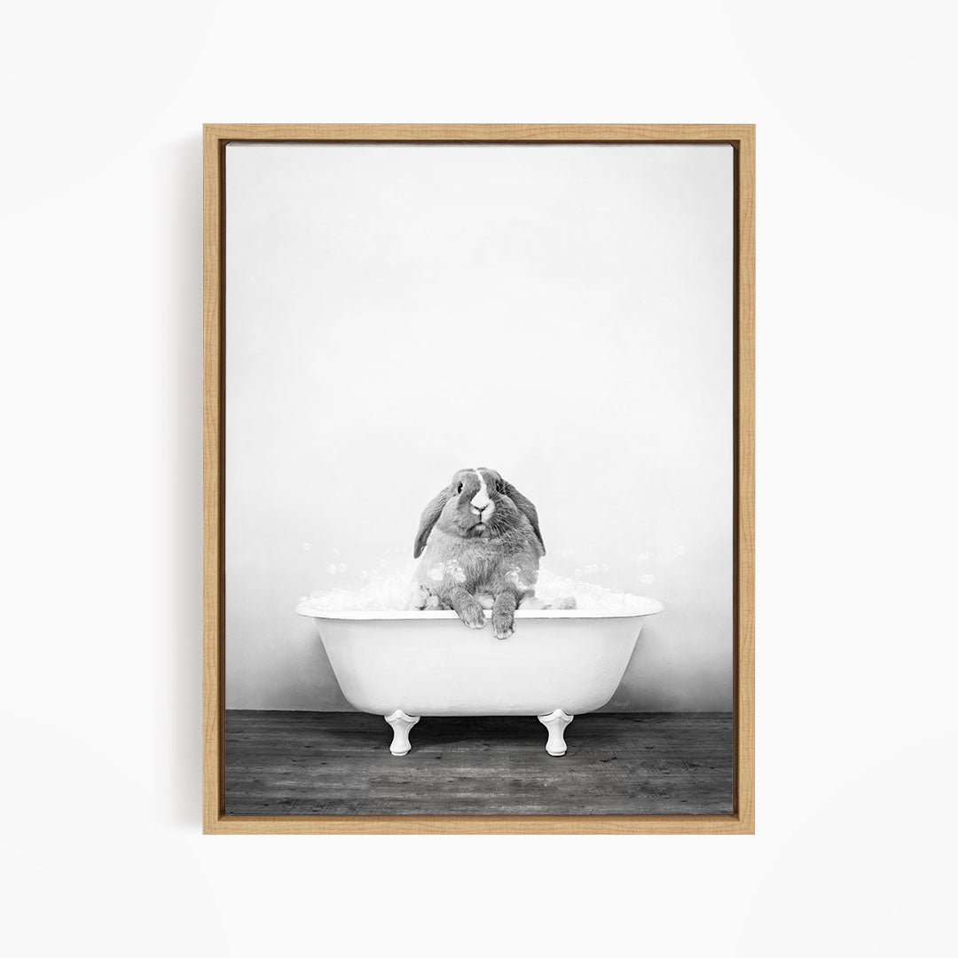 A rabbit sitting in a bathtub filled with water, enjoying a bath.