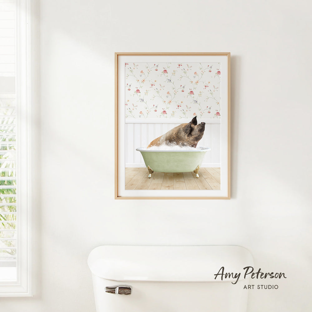 A framed image of a pig sitting in a bathtub, surrounded by a floral pattern on the wall behind it.