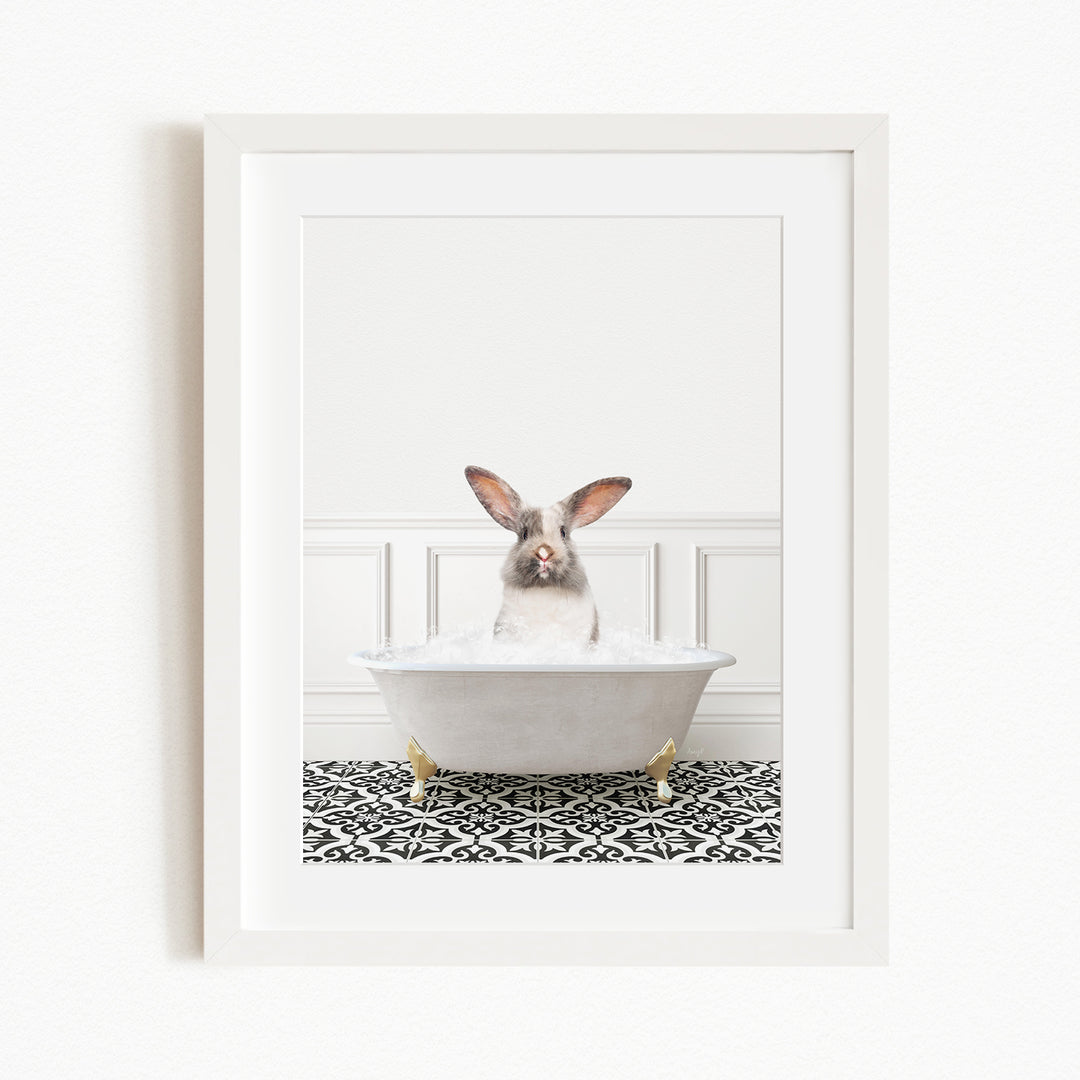 A white rabbit sitting in a white bathtub filled with bubbles, with its head peeking out from the tub.