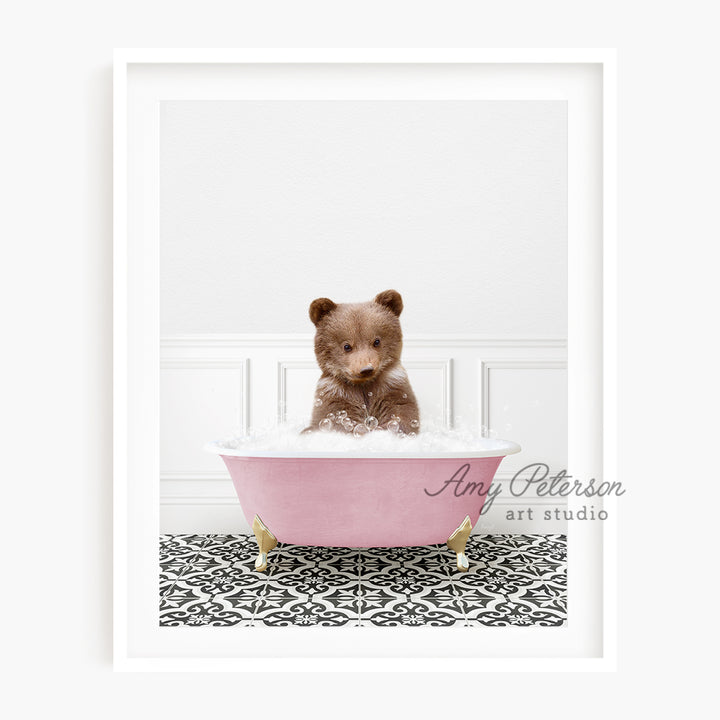 a brown teddy bear sitting in a pink bath tub